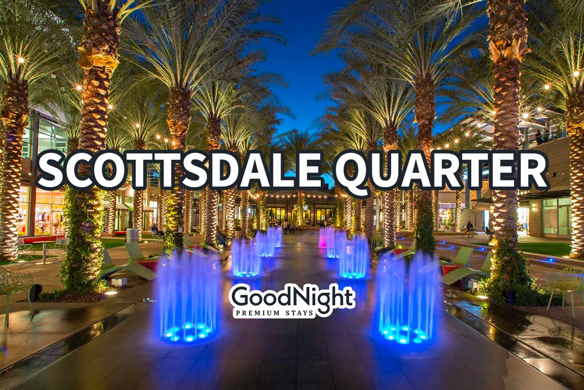 A lively outdoor scene with colorful water fountains, palm trees, and modern architecture, hinting at nearby upscale dining and vibrant social life. The area invites leisurely strolls and al fresco dining, echoing references to the Scottsdale waterfront and romantic dinner options.
