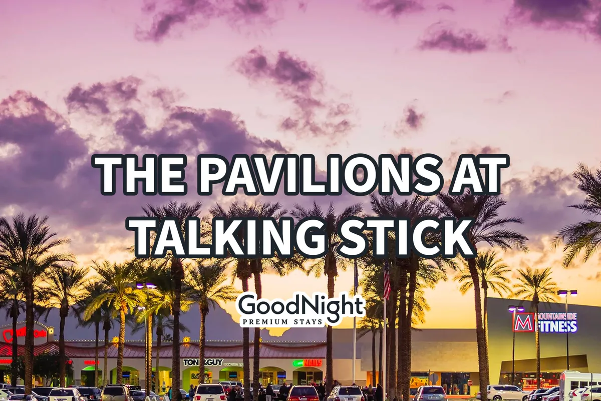 An exterior street view featuring palm trees, glowing retail signage, and a colorful sunset sky, capturing the relaxed yet energetic ambiance of Old Town Scottsdale as evening sets in. This scene hints at nightlife activities, outdoor dining, and community events just a stroll away.