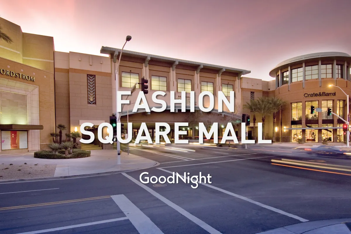 A festive view of the Fashion Square Mall area, with prominent Nordstrom and Crate & Barrel storefronts, palm trees, and shoppers mingling under bright skies. The scene hums with activity, inviting viewers to imagine themselves shopping, dining, and people-watching at one of Scottsdale’s premier retail and entertainment destinations.