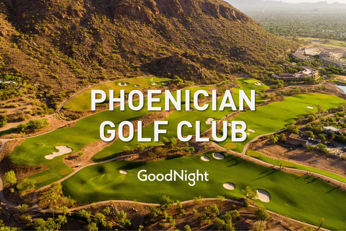 A sweeping shot of a lush, green golf course with rolling fairways, mountain views, and luxurious amenities. The setting is bright and welcoming, ideal for golfers and those who enjoy socializing outdoors.